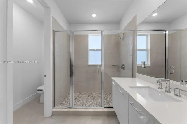 a bathroom with a double vanity sink and mirror