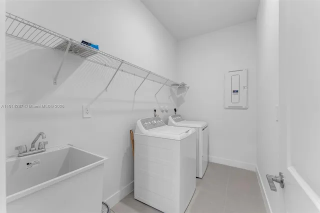 a utility room with a sink dryer and washer