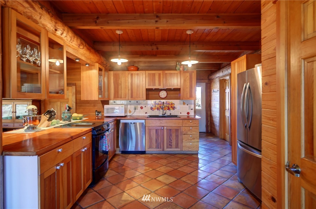 6 Beaver Pond Road Twisp, WA 98856 - Photo 11 of 40 a kitchen with stainless steel appliances granite countertop a stove a sink dishwasher and a refrigerator