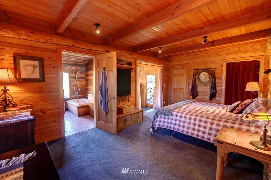 6 Beaver Pond Road Twisp, WA 98856 - Photo 15 of 40 a bedroom with a bed and wooden furniture