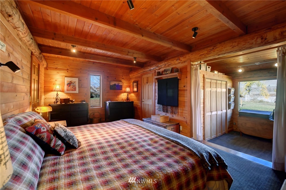6 Beaver Pond Road Twisp, WA 98856 - Photo 16 of 40 a large bedroom with a bed and wooden floor