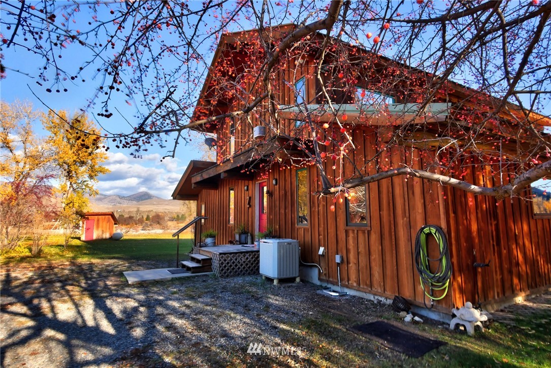 6 Beaver Pond Road Twisp, WA 98856 - Photo 25 of 40 a backyard of a house with barbeque oven table and chairs