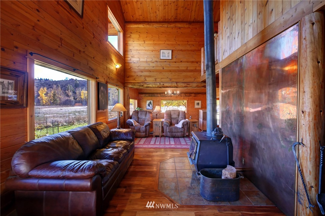 6 Beaver Pond Road Twisp, WA 98856 - Photo 31 of 40 a living room with furniture and a floor to ceiling window