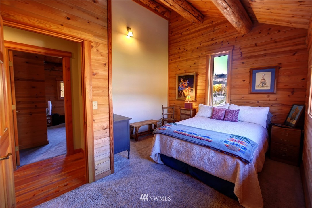 6 Beaver Pond Road Twisp, WA 98856 - Photo 33 of 40 a bedroom with a bed and wooden floor