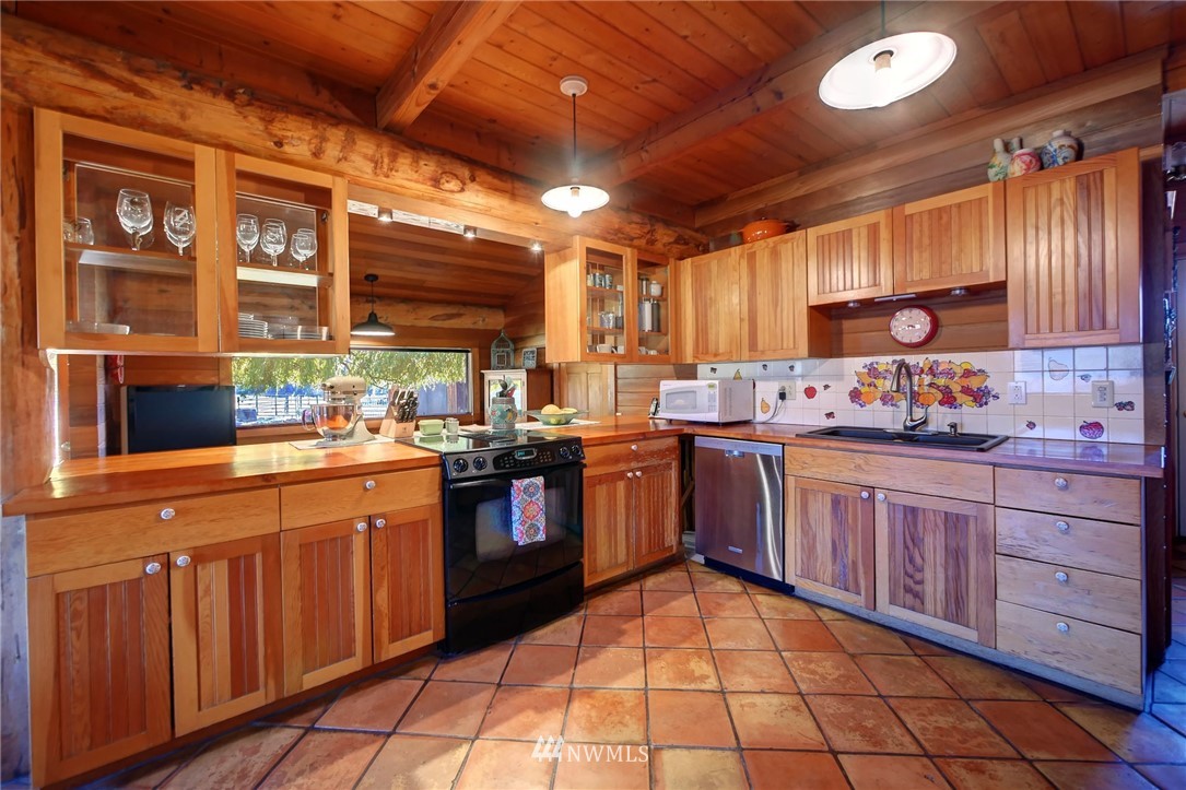 6 Beaver Pond Road Twisp, WA 98856 - Photo 10 of 40 a kitchen with stainless steel appliances granite countertop a stove sink and cabinets