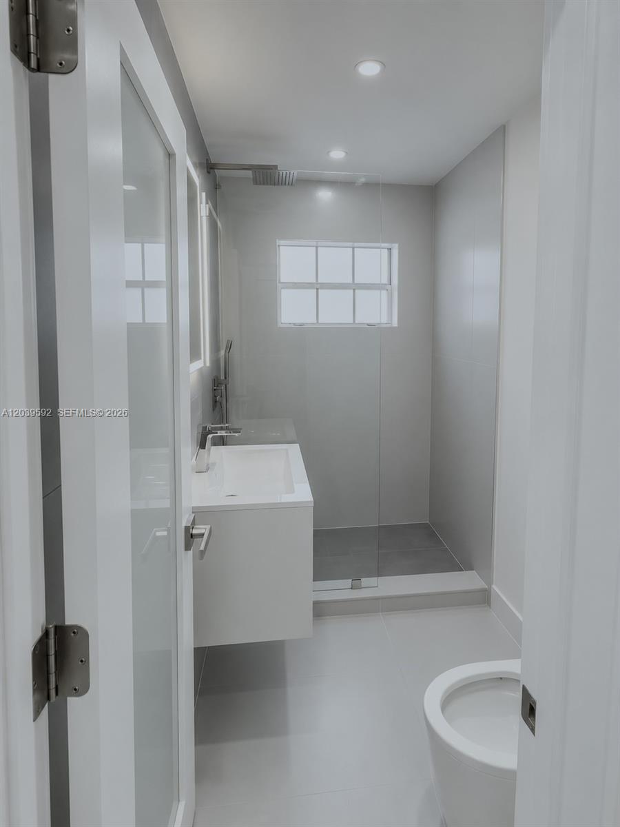 18935 Northwest 8th Avenue Miami Gardens, FL 33169 - Photo 18 of 26 a bathroom with a sink and shower