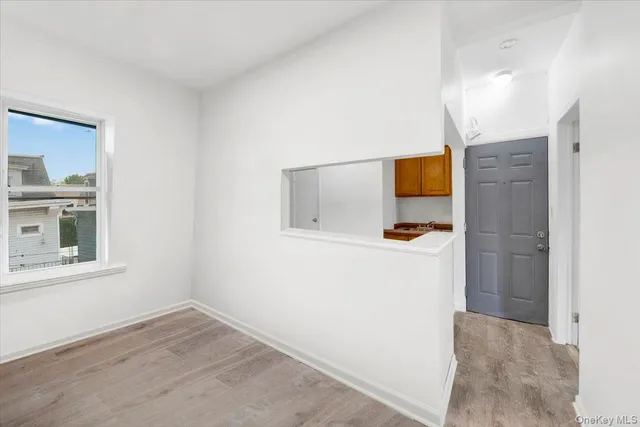 a hallway with a window and a mirror