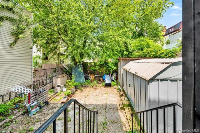 a view of a wooden deck and a backyard