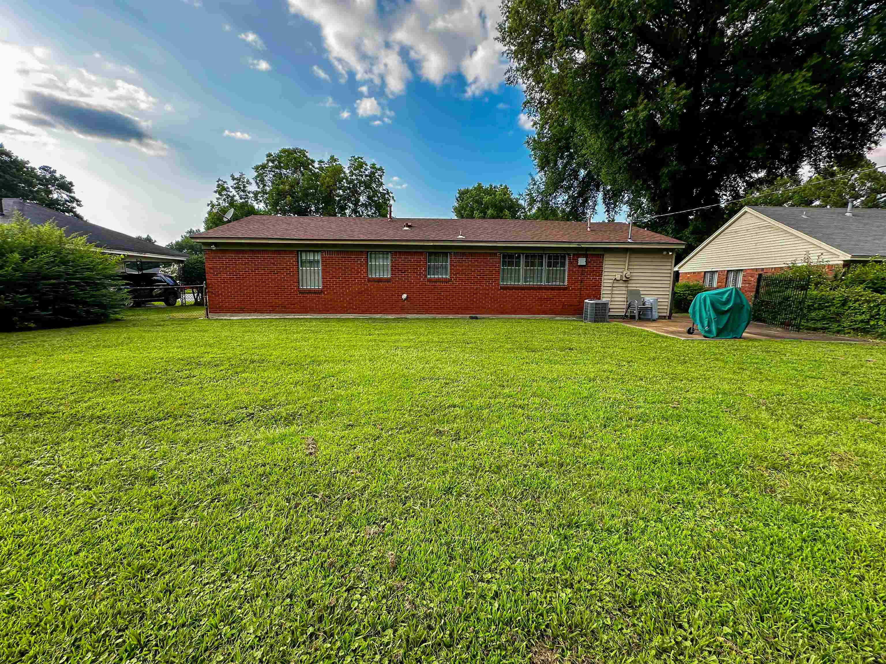 697 Shell Ln Avenue Memphis, TN 38109 - Photo 14 of 20 Back of house with central AC unit and a yard