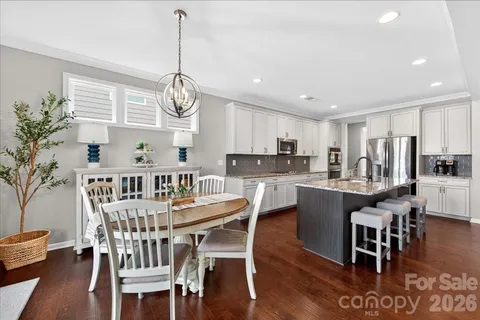 a living room with furniture kitchen view and a dining table