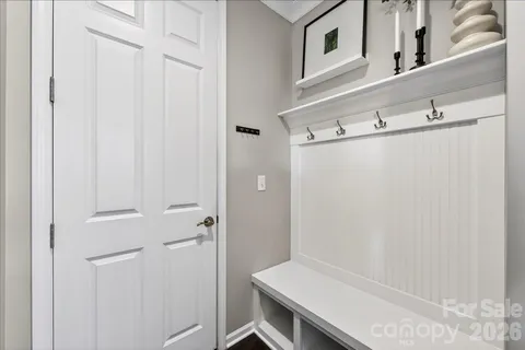 a view of a hallway with a livingroom and entryway