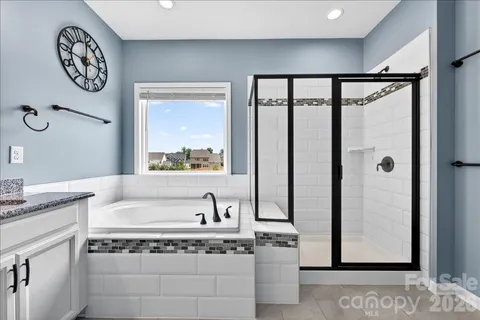 a bathroom with a granite countertop sink toilet and mirror