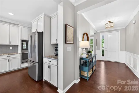 a view of a livingroom with furniture front door and wooden floor
