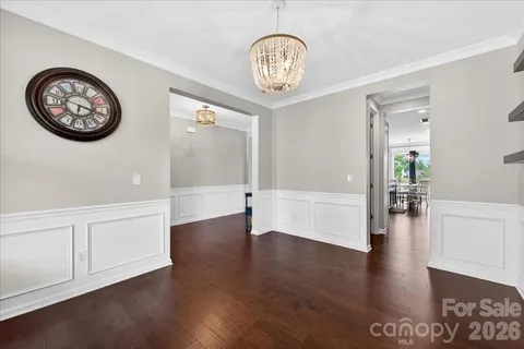a large kitchen with kitchen island granite countertop a table chairs sink and refrigerator