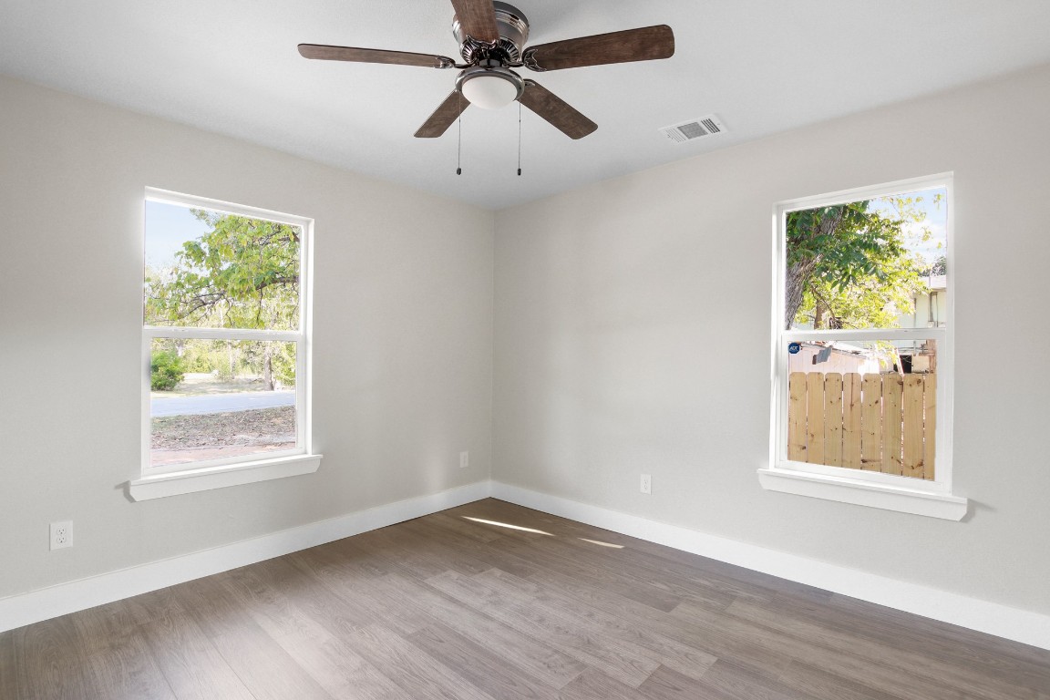 713 Burkett Street Taylor, TX 76574 - Photo 19 of 25 a view of an empty room with wooden floor and a window