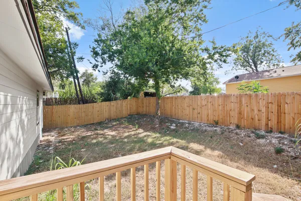a view of a backyard with wooden fence