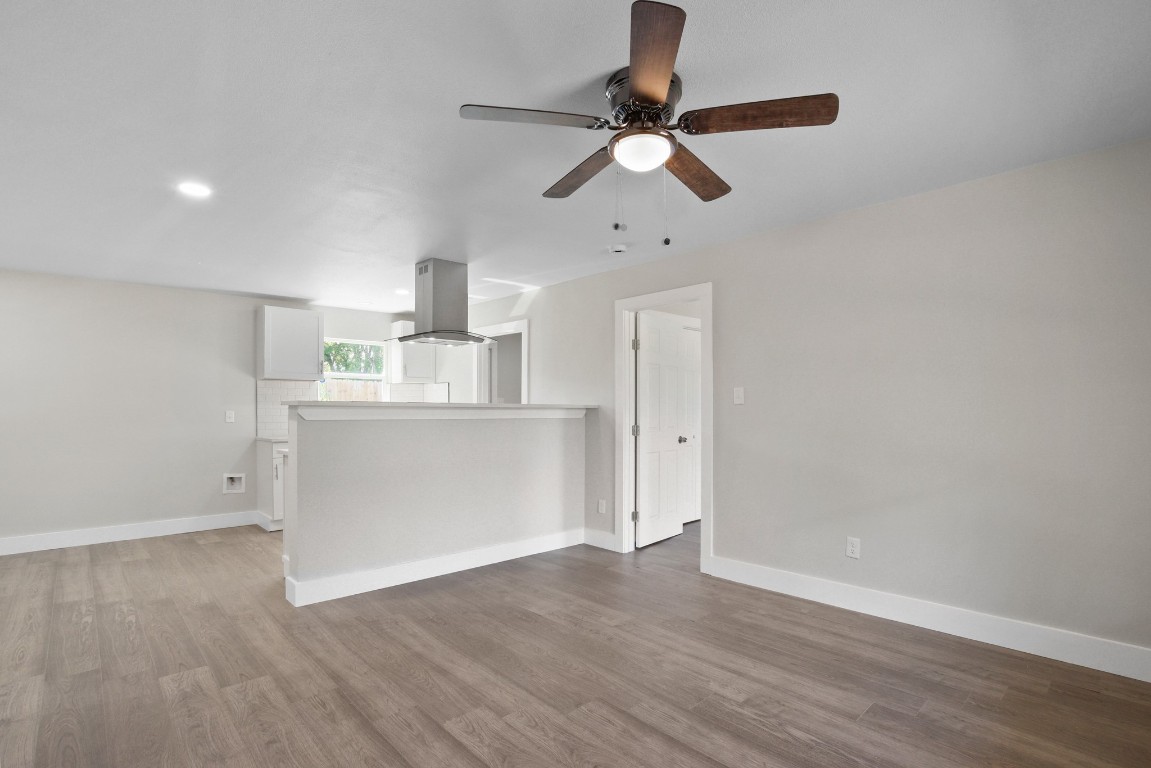 713 Burkett Street Taylor, TX 76574 - Photo 5 of 25 a view of kitchen with wooden floor electronic appliances and window