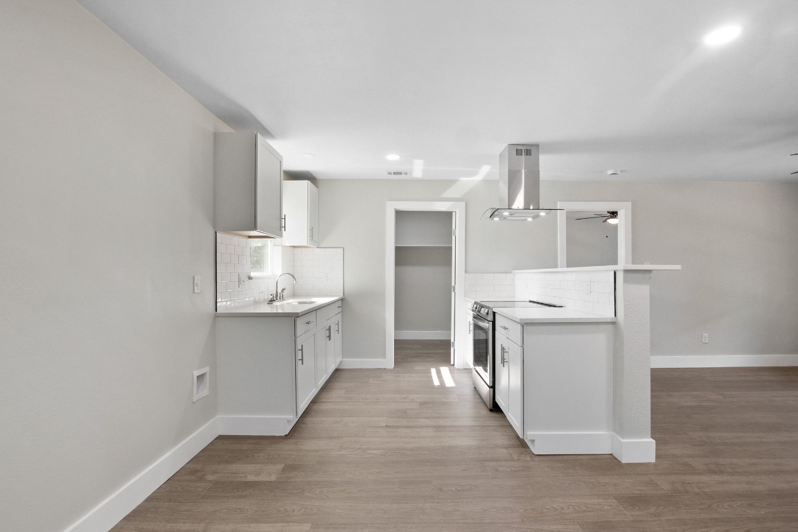 713 Burkett Street Taylor, TX 76574 - Photo 7 of 25 a kitchen with a sink a stove and refrigerator