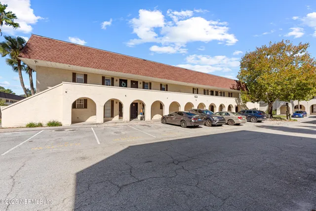 a front view of a building with parking