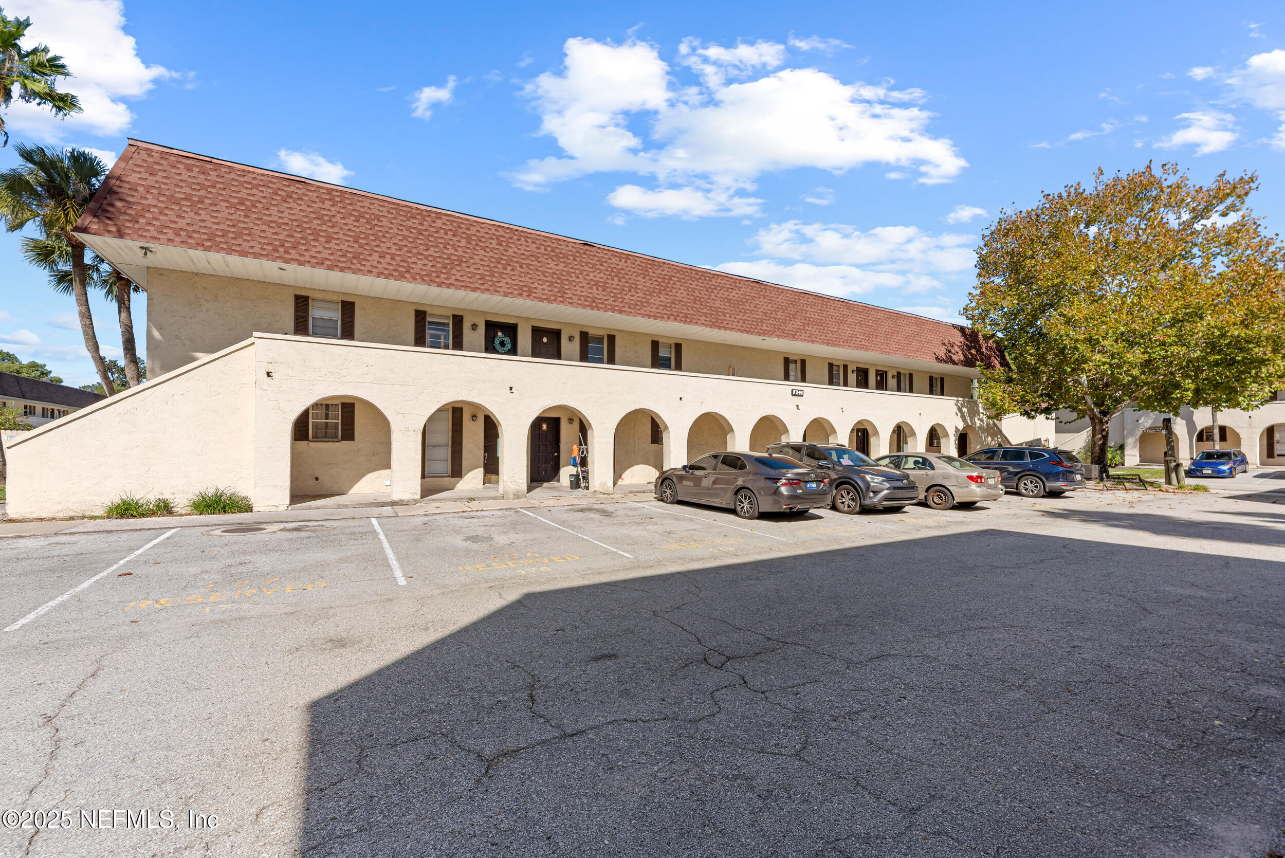 a front view of a building with parking