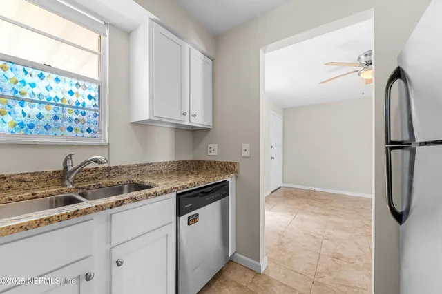 a kitchen with a refrigerator and a sink
