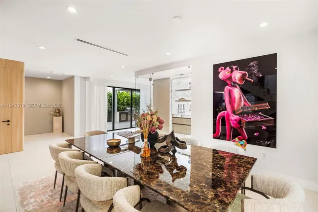 a kitchen with stainless steel appliances kitchen island granite countertop a refrigerator and cabinets