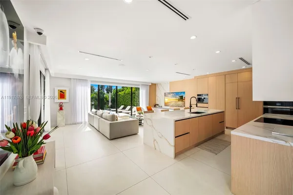 a kitchen with stainless steel appliances a table and chairs in it