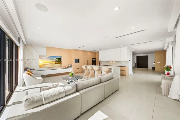 a kitchen with stainless steel appliances granite countertop a sink and white cabinets