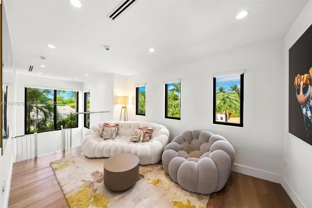 a bedroom with a bed couch and a large window