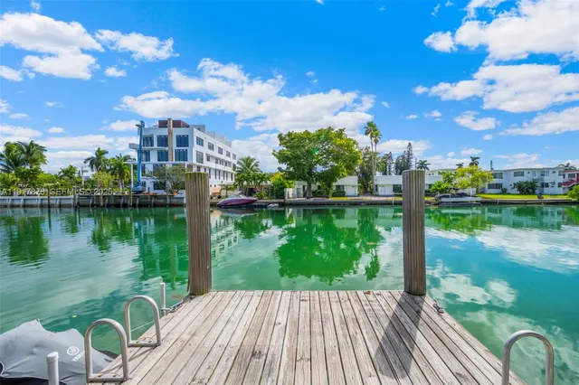 a front view of a house with a garden and trees