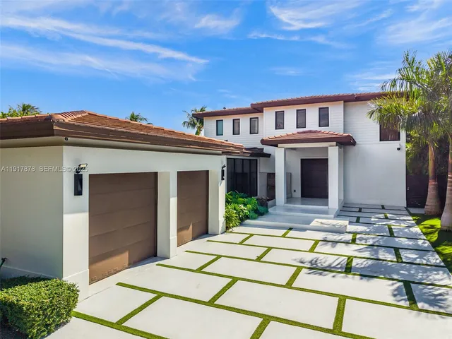 a view of a house with palm trees
