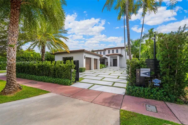 a view of a house with palm trees