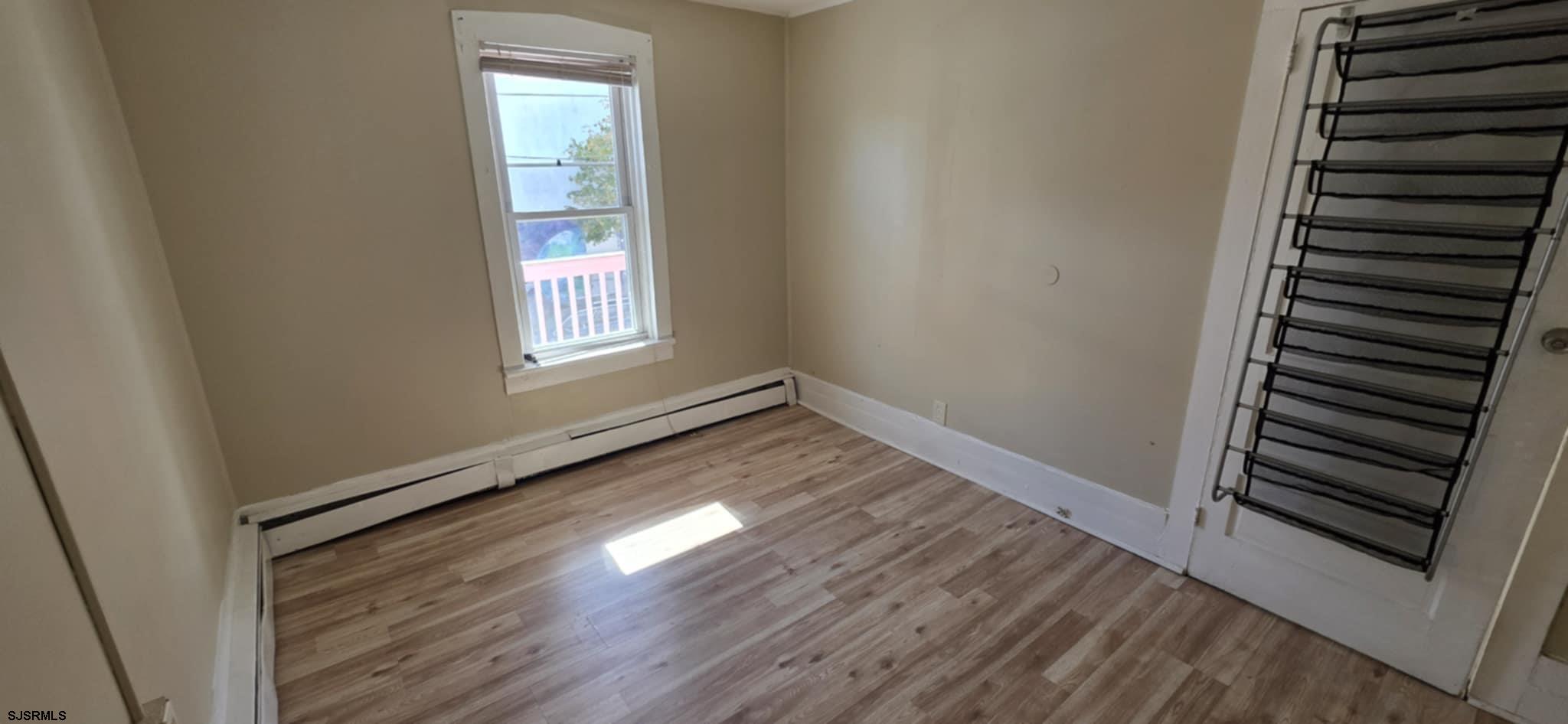 1419 Drexel Avenue, Unit 2 Atlantic City, NJ 08401 - Photo 5 of 9 an empty room with wooden floor