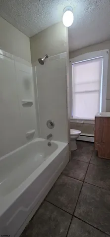 a bathroom with a tub and a sink
