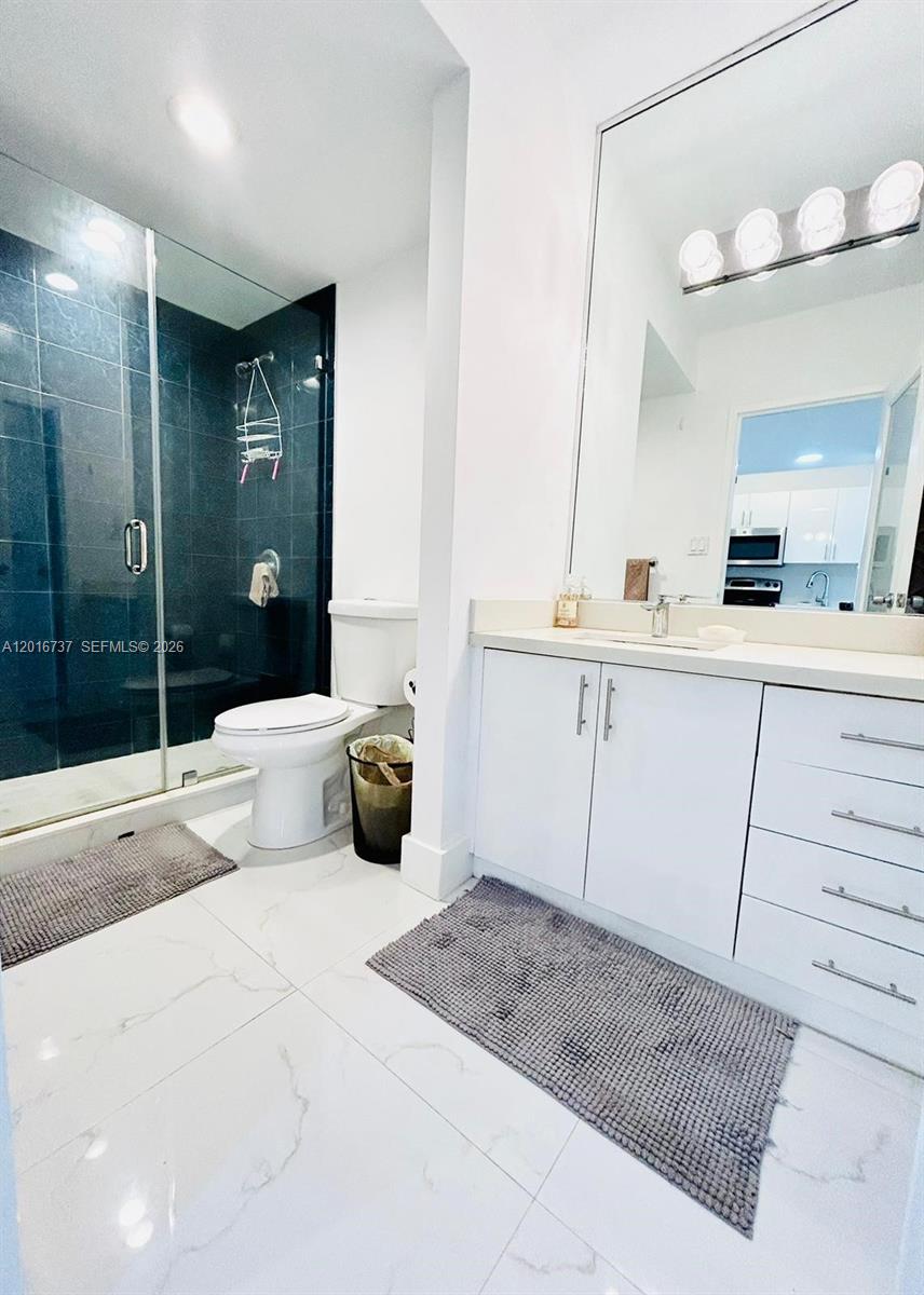 100 Lincoln Road, Unit 1526 Miami Beach, FL 33139 - Photo 7 of 9 a large bedroom with a large bed and a chandelier