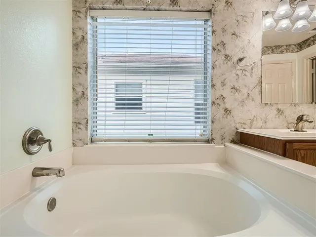 a bathroom with a bathtub and a sink