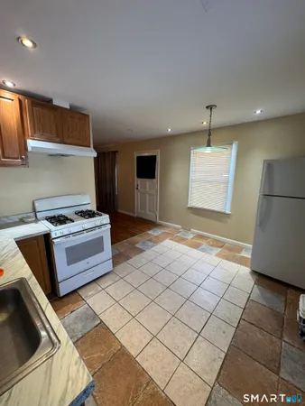 a kitchen with a stove and a refrigerator