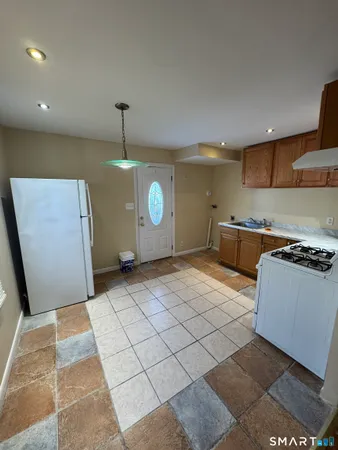 a kitchen with stainless steel appliances granite countertop a sink and a stove