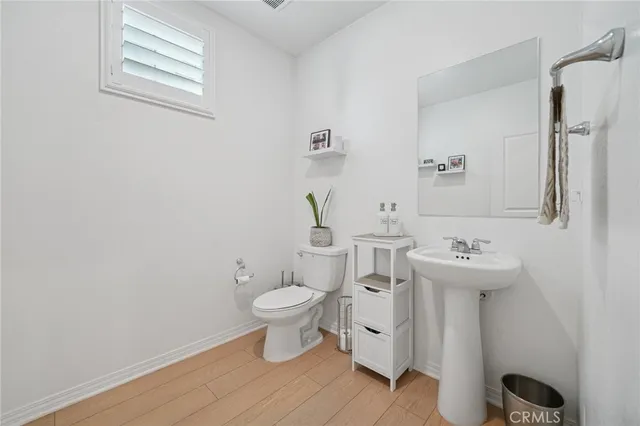 a bathroom with a sink toilet and a mirror