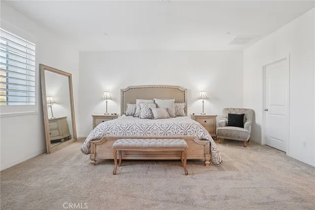 a bedroom with a bed and lamp