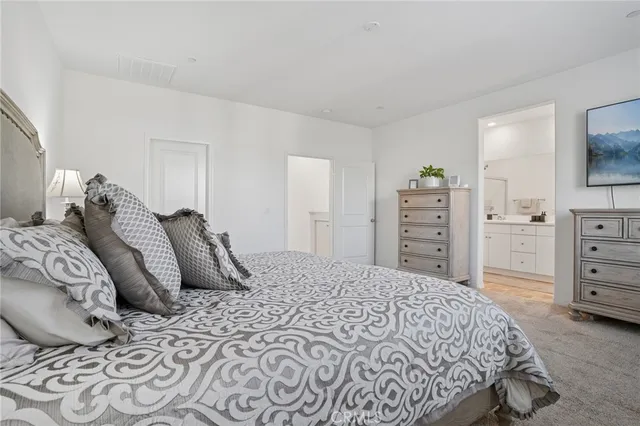 a bedroom with a bed and dresser