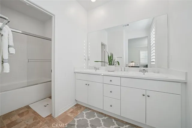 a bathroom with a double vanity sink and mirror