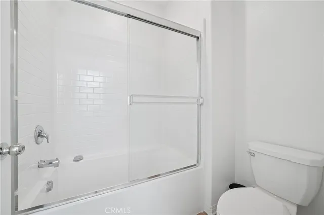 a bathroom with a shower and toilet
