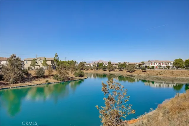 a view of a lake with houses in the back