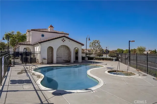a swimming pool with outdoor seating and yard