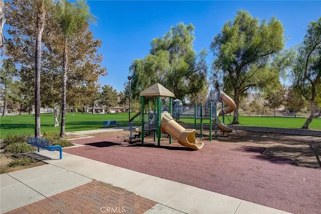 a garden with trees in the background