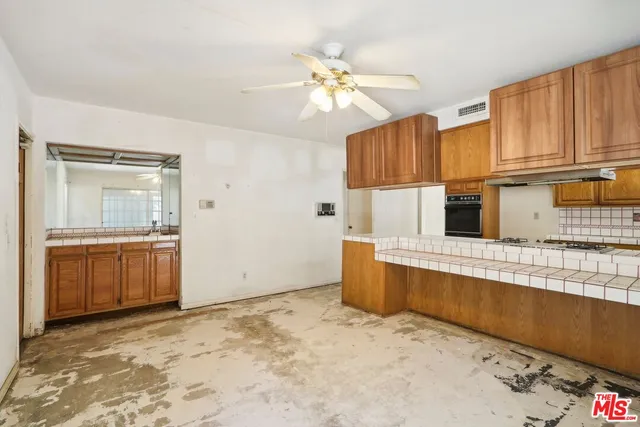 a kitchen with a refrigerator sink and cabinets