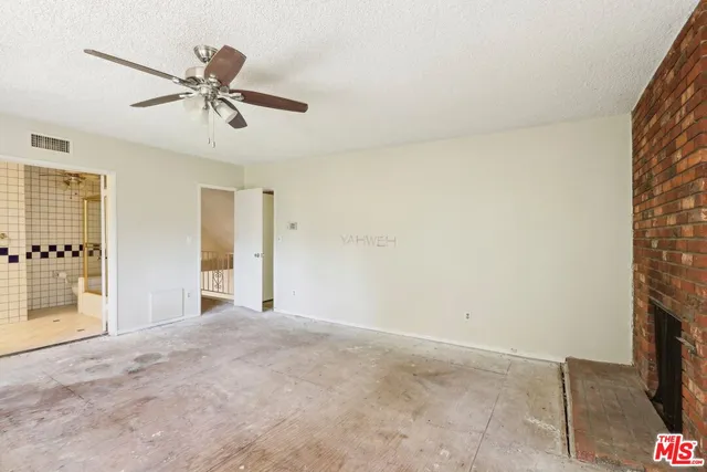 a view of a livingroom with a ceiling fan and window