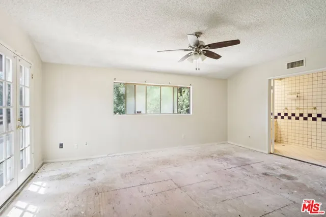 a view of a livingroom with a ceiling fan and window