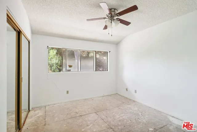 a view of a room with a ceiling fan